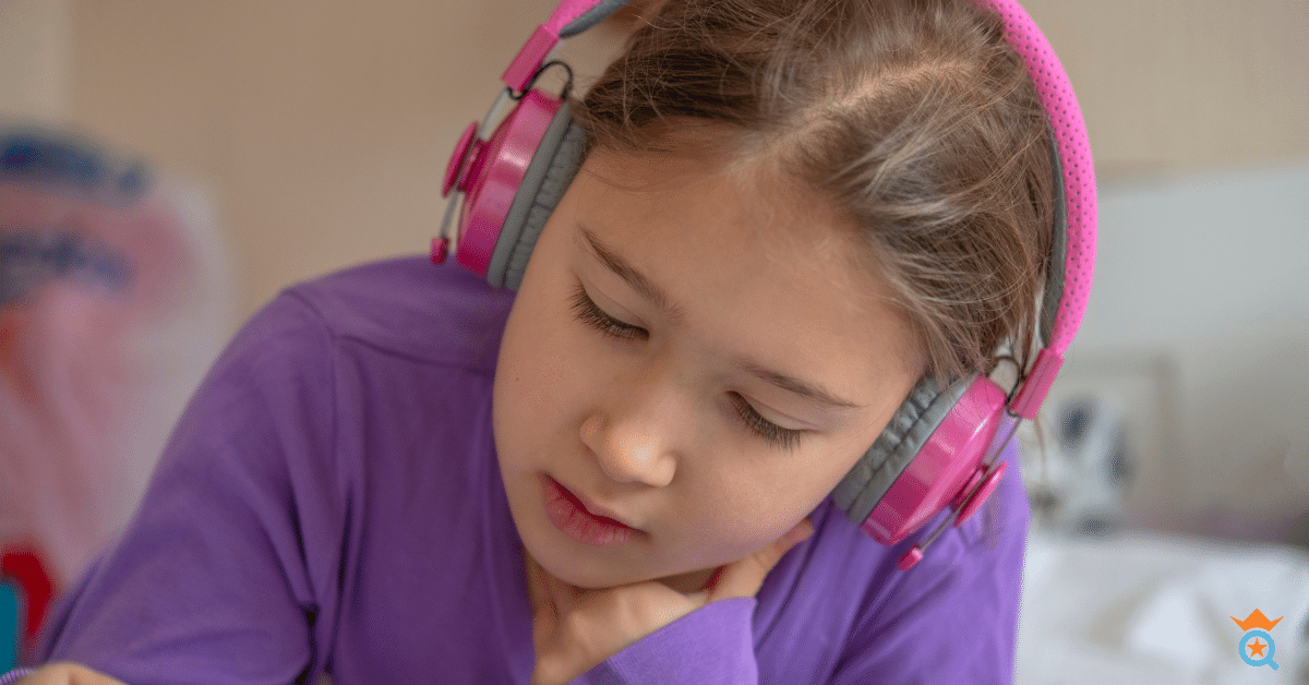 little girl wearing pink headphone